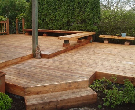 Cedar deck with built-in seating by landscaper Environmental Construction