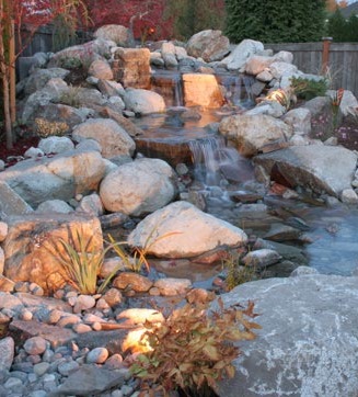 Water feature with outdoor lighting, designed by Environmental Construction, Inc.